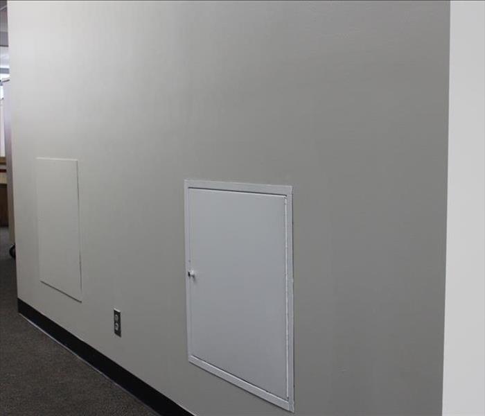 cream wall with a white mini door