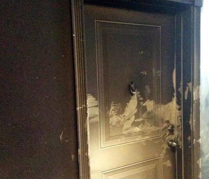 door and wall blackened with soot