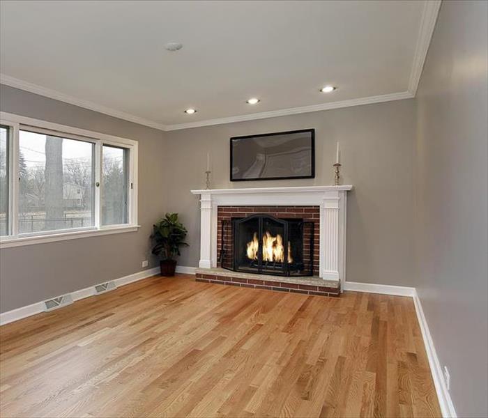 living room with grey walls and hardwood flooring and a fire place