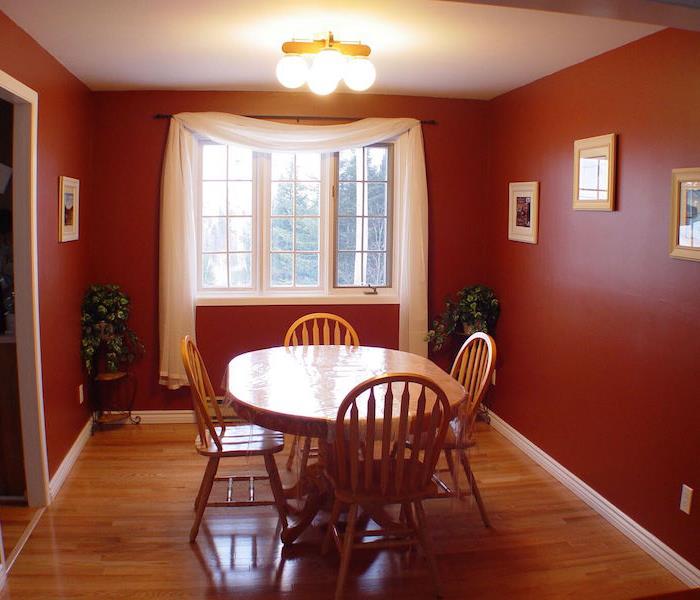 dining room with red walls and hardwood flooring