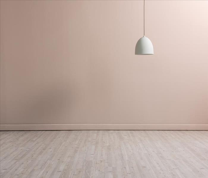 pinkish wall with light wood flooring