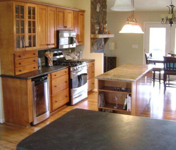 kitchen with wood cabinets and black counter tops
