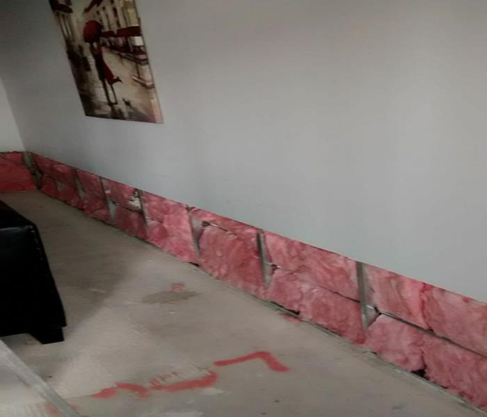 drywall removed from the bottom two feet exposing the pink insulation