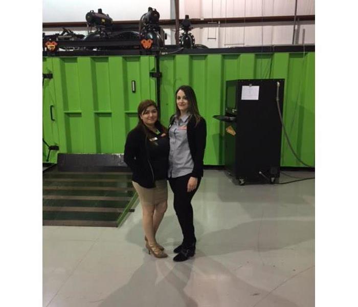 two SERVPRO employees standing in a warehouse