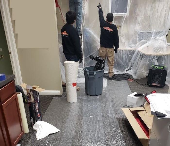 SERVPRO technicians with containment and manual cleanup equipment
