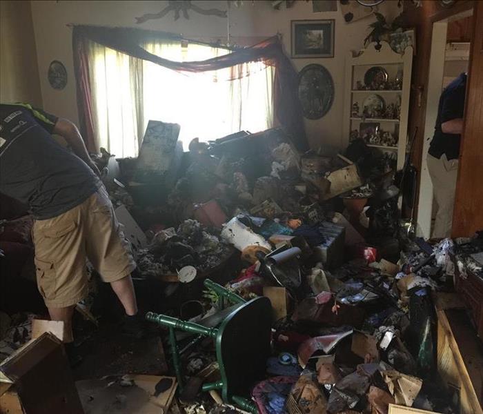 living room with fire damaged items covering the floor