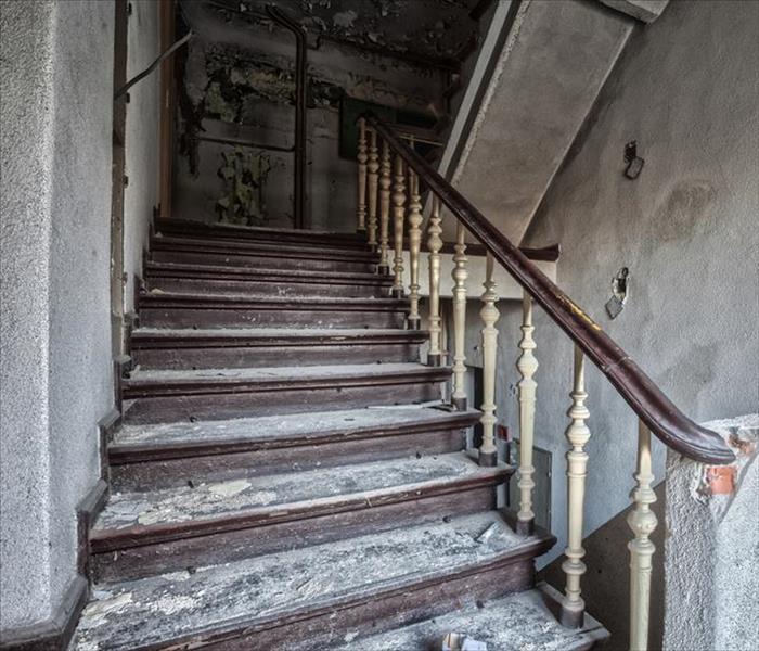 stairs covered in soot damage and debris