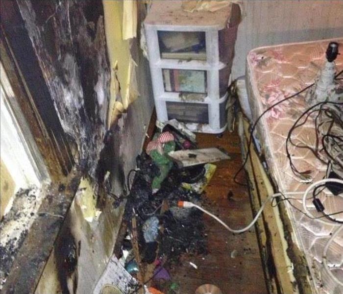 A room that suffered fire damage with soot and smoke covering all areas