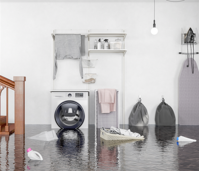 flooded laundry room with items floating everywhere